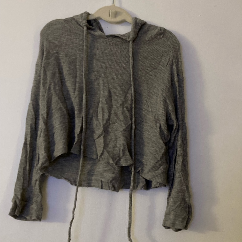 grey cropped sweater with a hood.